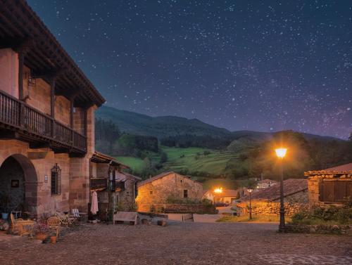 a town at night with a star filled sky at La Infinita Rural Boutique in Carmona