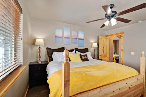 a bedroom with a bed and a ceiling fan at Cubbyz Cabin in Garden City