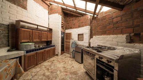 a kitchen that is being remodeled with a brick wall at Casa de las Olas in Mazunte