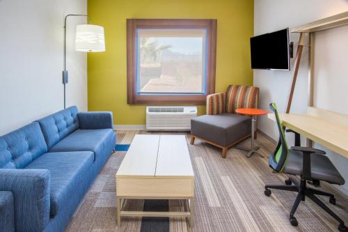 a living room with a couch and a table at Holiday Inn Express & Suites Pahrump by IHG in Pahrump