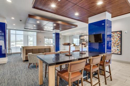 an office with a large table with chairs and a couch at Holiday Inn Express & Suites - Denton South by IHG in Denton