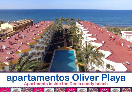 an aerial view of a hotel with a beach and the ocean at Apartamentos Oliver Playa in Denia