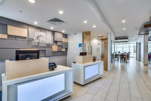 a lobby of a hospital with boxes on the walls at Holiday Inn Express & Suites - Denton South by IHG in Denton