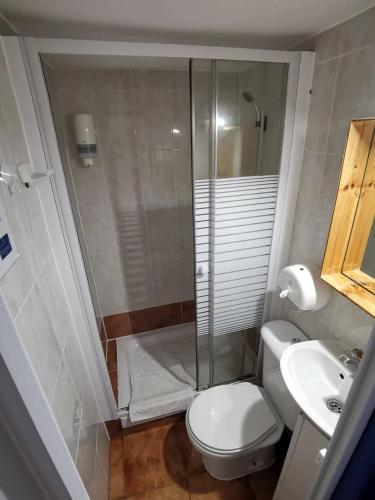 a bathroom with a shower and a toilet and a sink at The Dreamers&Co in Córdoba