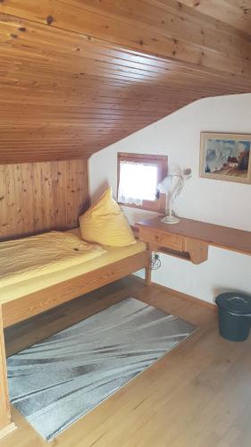 a room with a bunk bed and a desk at Haus Christoph in Bad Wiessee