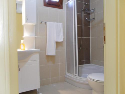 a bathroom with a shower with a toilet and a sink at Sirman Suite Hotel in Sarigerme