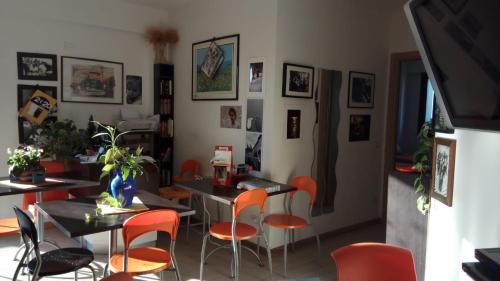 a dining room with orange chairs and a table at B&B Pontemare in Ancona