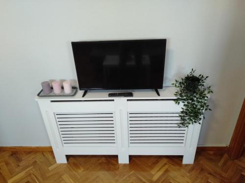 a tv on top of a white entertainment center at Airport Ifema Barajas Home in Madrid