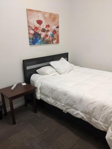 a bedroom with a white bed and a table at Koreana in Decorah in Decorah