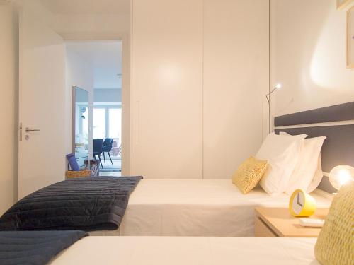 a bedroom with a large white bed and a mirror at Santos Stylish Cozy Apt – AC_Green Terrace in Lisbon