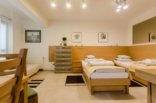 a room with three beds and a mirror at Family Apartments - Private Parking in Kraków