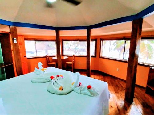 a bedroom with two beds with towels on them at Bananarama Dive & Beach Resort in West Bay
