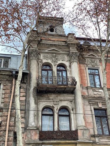 a building with a balcony on the side of it at Boutique Fantasy in Tbilisi City