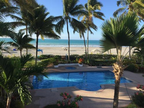 a view of the beach from the balcony of a resort at Precioso Dpto a 20 metros de la playa Con Aire Acondicionado en Club Casablanca in Same