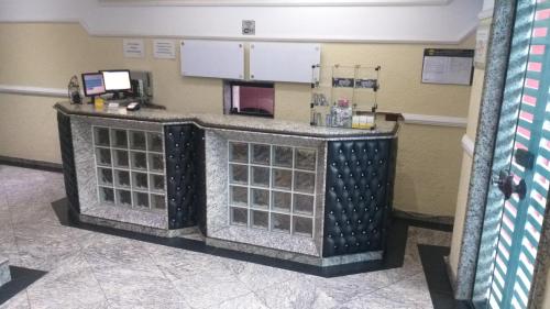 a waiting room with a counter in a hospital at Millenium Hotel in Sao Paulo