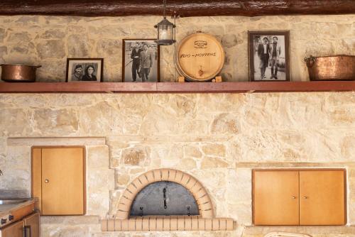 two shelves on a stone wall with a fireplace at Prinus Country Retreat Apokoronas, heated pool, 13km from the sea in Embrósneros