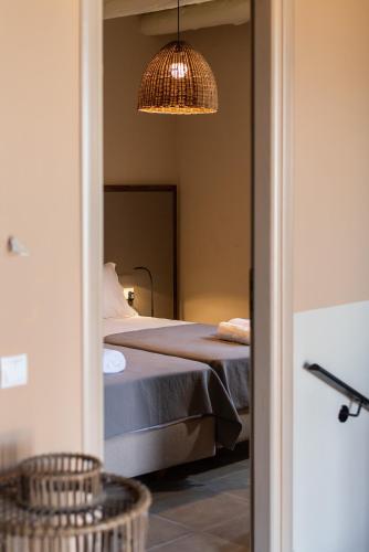 a bedroom with a bed and a hanging light at Prinus Country Retreat Apokoronas, heated pool, 13km from the sea in Embrósneros