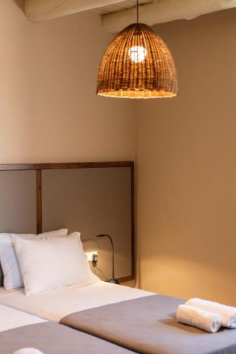 a bedroom with a bed and a lamp and a light at Prinus Country Retreat Apokoronas, heated pool, 13km from the sea in Embrósneros