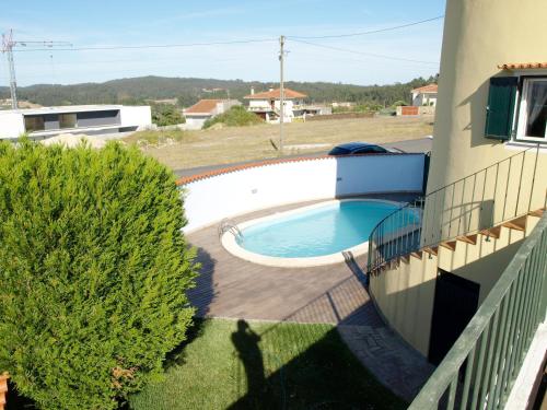 a swimming pool in a yard next to a building at Villa Moino in Barcelos