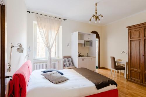 a bedroom with a large bed and a desk at Residenza del Cedro in Rome