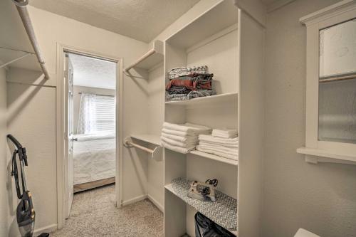 a walk in closet with white shelves and towels at Game Day Retreat Pool Access, 2 Mi to Texas A and M in College Station