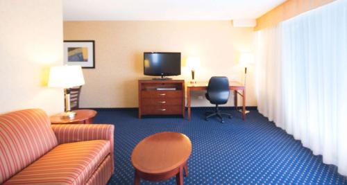 a living room filled with furniture and a tv at Best Western Plus Suites Downtown Calgary in Calgary