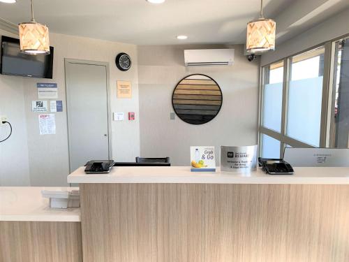 a reception counter in a dental office with a mirror at Best Western Andersen's Inn in Santa Nella Village