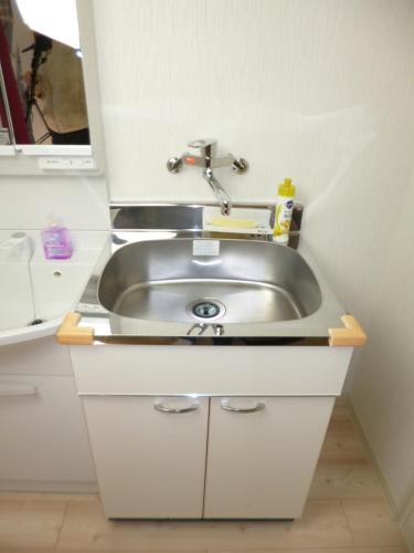 a sink in a small white kitchen with a counter at THE MICKEY CARLTON Ohashi 201 in Shiobaru