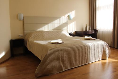 a bedroom with a bed with two towels on it at Hotel Trevi in Prague