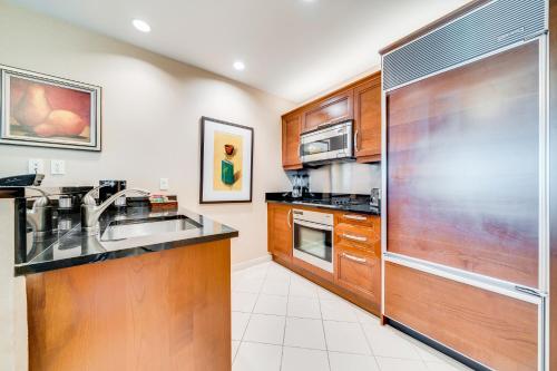 a kitchen with a sink and a refrigerator at Jet Luxury at The Signature Condo Hotel in Las Vegas