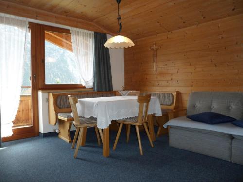 a dining room with a white table and chairs at Haus Maria in Bach