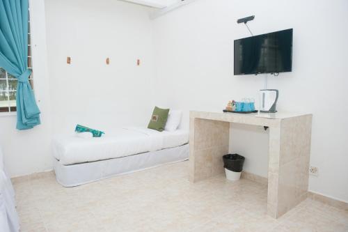 Postel nebo postele na pokoji v ubytování IBAI BEACH GUESTHOUSE