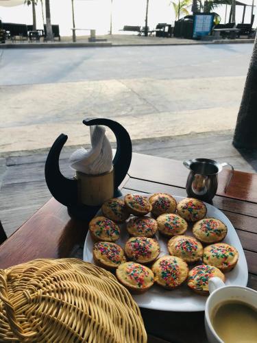 a plate of donuts on a table with a drink at Hotel Luna De Plata in Mahahual