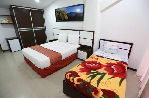 a bedroom with two beds in a room with at Posada Villa del Carmen in Catia La Mar