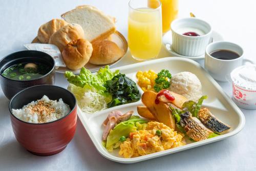 a plate of food with rice and vegetables and bread at Hiroshima Intelligent Hotel Stadium Mae in Hiroshima