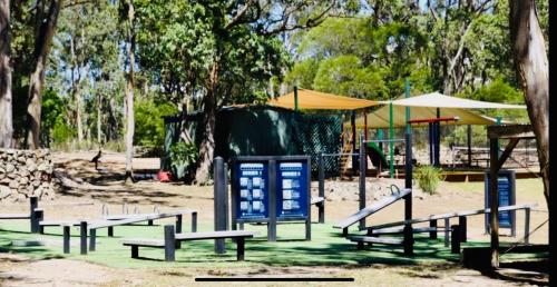 a park with a bunch of benches and a playground at Valley View Luxury Retreat in Vacy
