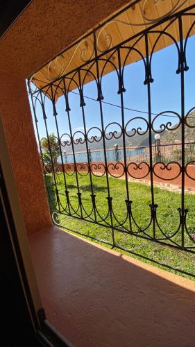 a window with a view of a baseball field at Scenic Lakeview House Near 5-Star Widian Hotel in Bine el Ouidane