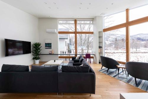 a living room with a couch and a table at Alpinarc Chalet by Hakuba White Fox Company in Hakuba