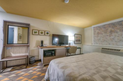 a hotel room with a bed and a desk at Holiday Inn Tacoma Mall by IHG in Tacoma