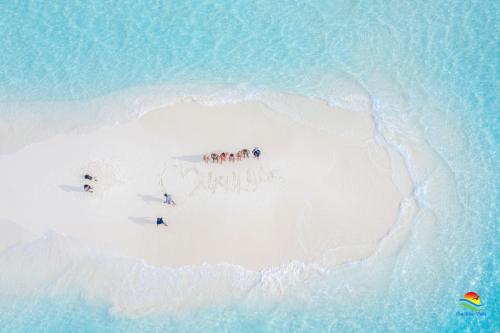 a group of people on an island in the ocean at Sea View Villa Ukulhas in Ukulhas