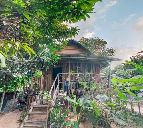 a small wooden house with a staircase in front of it at Sok Phen Homestay in Siem Reap