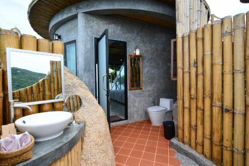 a bathroom with a toilet and a sink at Sai Daeng Resort in Koh Tao