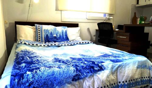 a blue and white bed in a room at RiX Studio Park Famagusta Contactless Check In & Check Out in Mağusa