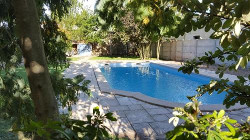 a swimming pool in the backyard of a house at La Closeraie in Champagné-les-Marais