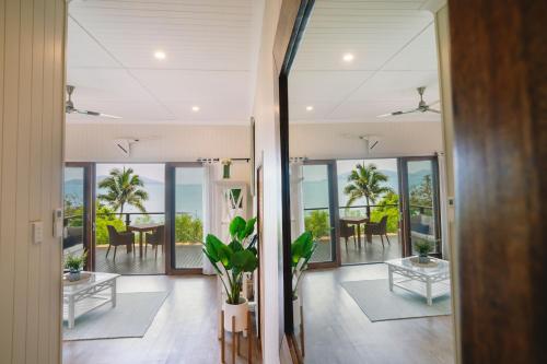 a hallway of a house with a view of the ocean at Palm Bay Resort in Long Island