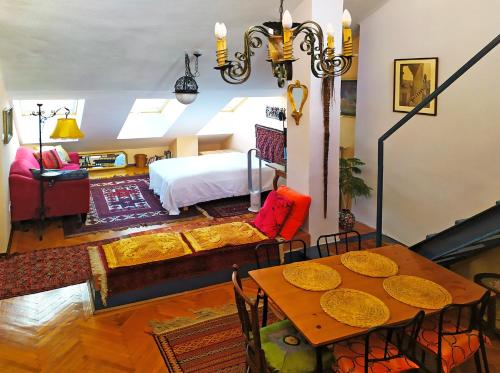 a living room with a bed and a table at Margaret Apartment for 5 people with Panorama Terrace in Budapest