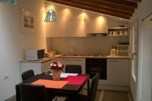 a kitchen with a dining room table and a kitchen with a table and chairs at CHARMING HOUSE IN VENICE in Venice