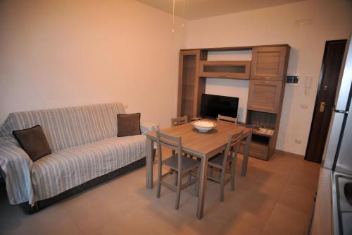 a living room with a table and a couch at Coastal Cliff, Amalfi 2 in Pianillo