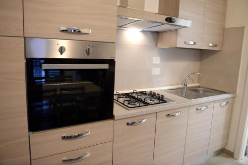 a kitchen with a stove top oven next to a sink at Coastal Cliff, Amalfi 2 in Pianillo