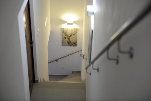 a stairway with a light and a painting on the wall at Coastal Cliff, Amalfi 2 in Pianillo